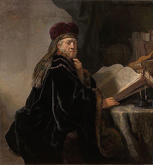A Scholar Seated at a Desk - Rembrandt HarMenszoon van Rijn